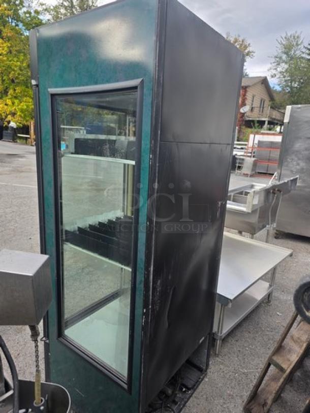 True GDM-26-LD Glass Door Merchandiser, one door, black exterior, visible shelving, in used condition.