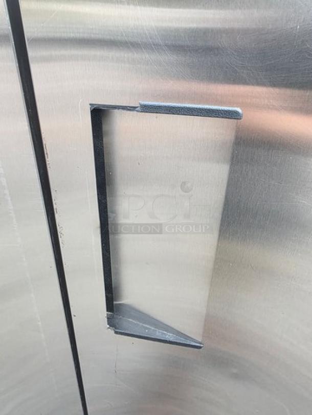 True T-72F T-Series 3-section reach-in freezer, solid doors, stainless steel, on casters, visible handle.