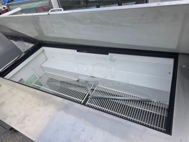 True QA-60-24M-B 60" refrigerated prep table with open lid, on casters. Stainless steel, clean interior, excellent condition.