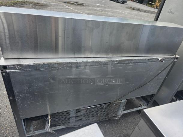True QA-60-24M-B 60" refrigerated prep table, stainless steel, on casters, fair condition. Model details on side.
