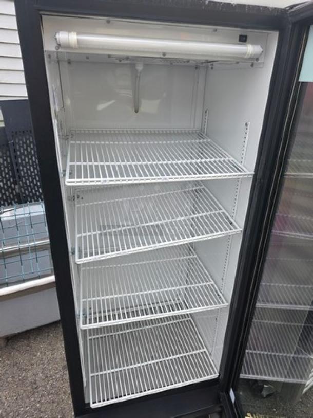 True GDM-12 glass door merchandiser, single swing, four adjustable shelves, clean condition, ideal for displaying beverages.