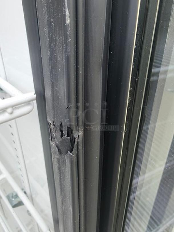 True GDM-12 single swing glass door merchandiser, visible wear on door frame, black finish, True model label on side.