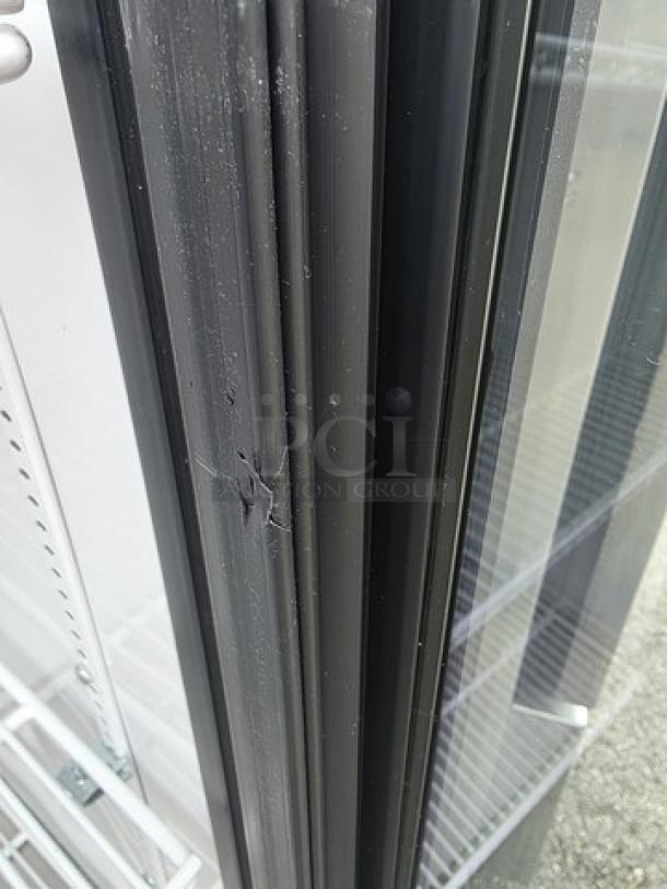 True GDM-12 merchandiser with single swing glass door, minor wear on door frame. Perfect for showcasing products.
