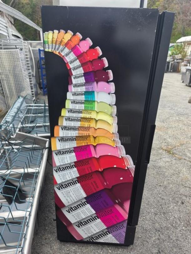 True GDM-12 Single Swing Glass Door Merchandiser, colorful Vitamin Water design, exterior view, good condition.