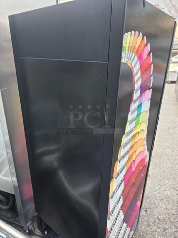 True GDM-12 Single Swing Glass Door Merchandiser, vibrant graphic side, excellent condition, ideal for retail display.