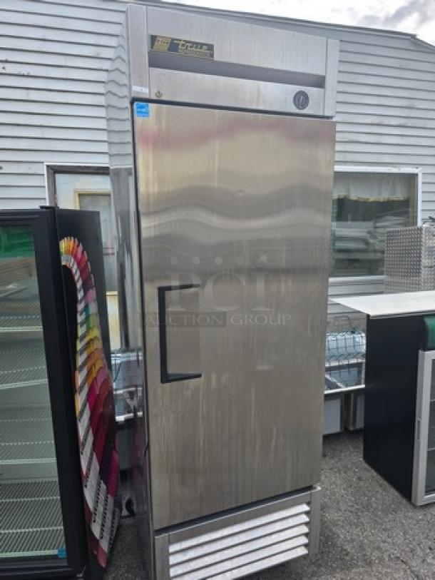 True T-23 Reach-in Solid Swing Door Refrigerator on casters, stainless steel finish, with True logo and control panel.