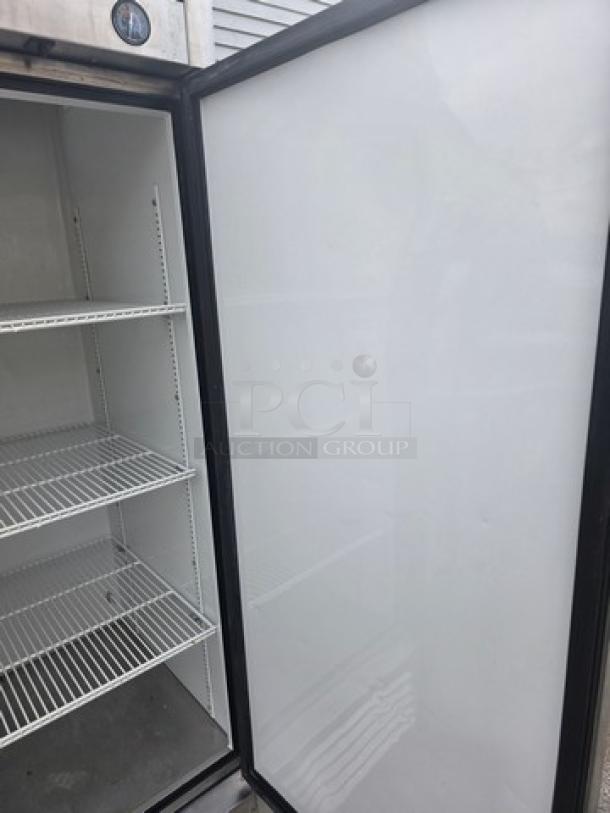 True T-23 Reach-in Refrigerator, solid swing door, interior shelves, on casters, clean, model T-23 visible.