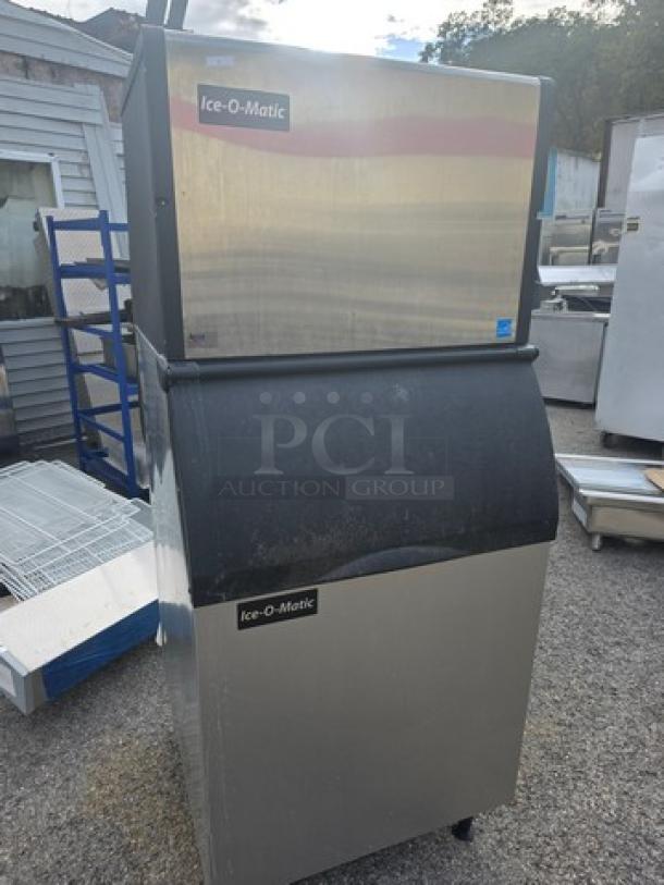 Ice-O-Matic ICE0500HA5 ice machine with bin, stainless steel, air-cooled, good condition, displayed outdoors.