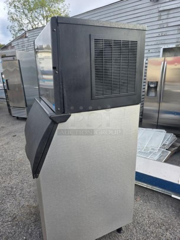 Ice-O-Matic ICE0500HA5 air-cooled ice machine with bin, stainless steel finish, outdoor setting, good condition.