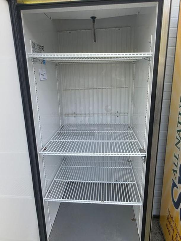 True T-23F Reach-in Freezer with solid swing door, on casters. Features three wire shelves. Good condition. Model T-23F label visible.