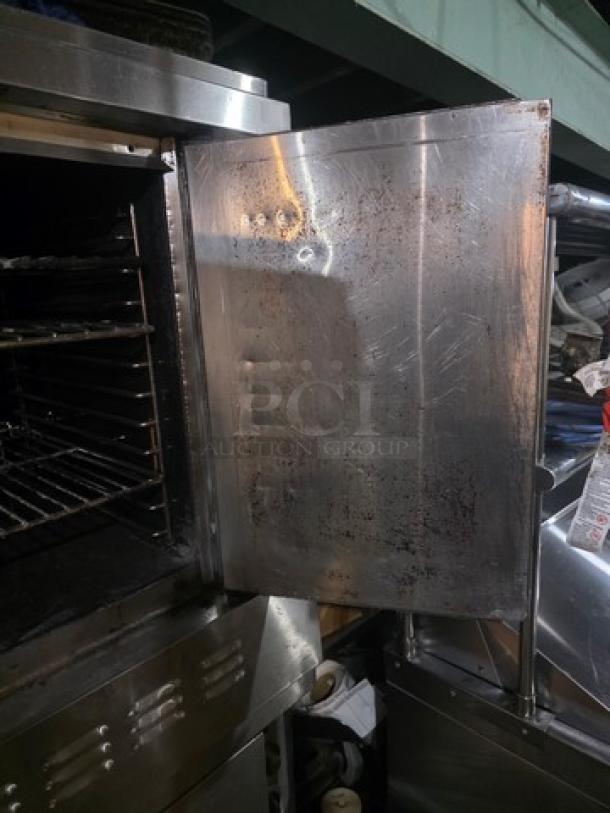 Blodgett SH1G-AA double stack natural gas convection ovens on casters. Visible wear on stainless steel exterior, open door showing interior racks.