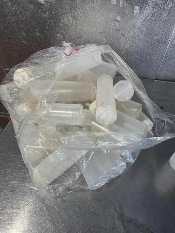 Lot of plastic squeeze bottles in clear bag; various sizes, good condition. Ideal for sauces or condiments.