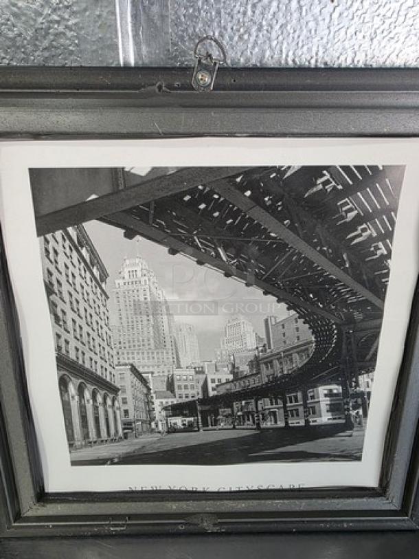 Black and white framed picture of a New York cityscape featuring elevated train tracks and skyscrapers.