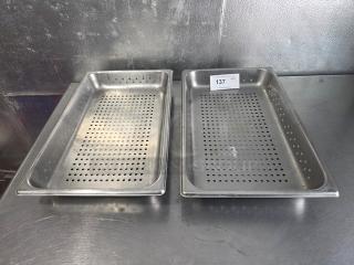 Lot of 2 perforated stainless steel food pans on metal surface; both in good condition. Item tag labeled "137."