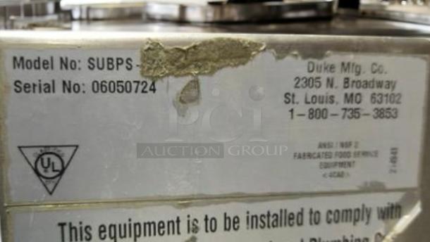 Model label on Duke SUBPS sink, includes model and serial numbers, company address, and certification markings.