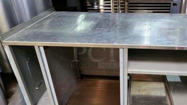 Stainless steel workstation cabinet by Custom Commercial Fabrication, features built-in power outlets, pull-out tray, superb condition.
