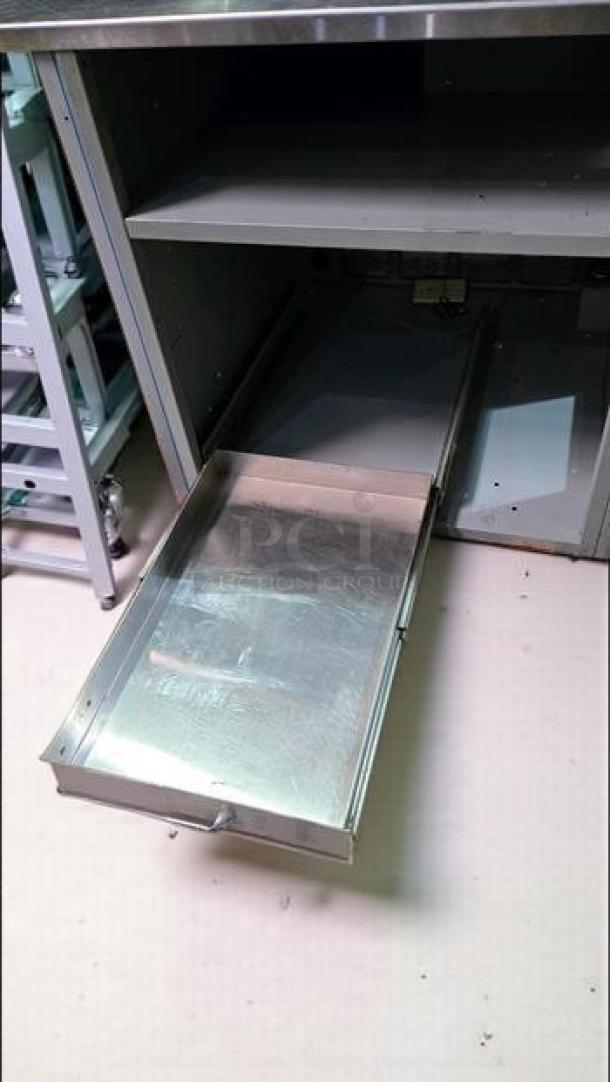 Stainless steel workstation cabinet with built-in outlets, pull-out tray, shelves, superb condition, Custom Commercial Fabrication.