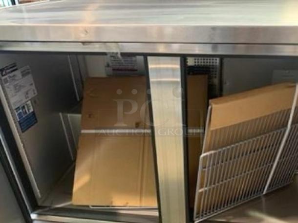True TUC-48-HC undercounter refrigerator in superb condition. Two doors, stainless steel, visible labels, 115V, fully tested.