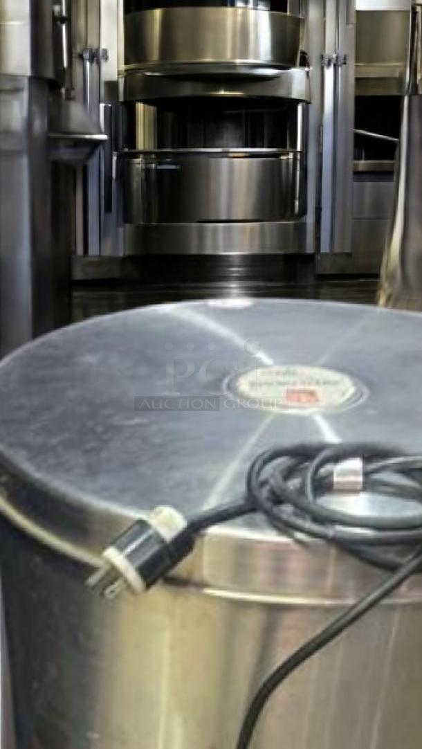 The Greens Machine commercial electric lettuce dryer, 115V, in great condition. Features metal exterior, visible power cord, and brand label.
