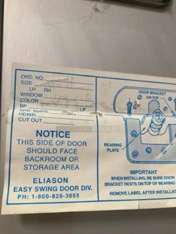 Eliason Easy Swing commercial traffic door in immaculate condition, features a window, ready for installation.