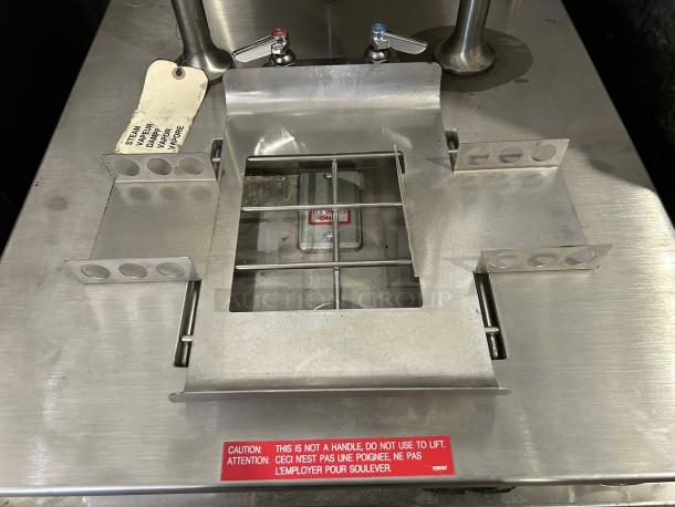 Cleveland 24-GM-K6-200 tilting steam kettle; stainless steel; tested; caution label; "STEAM VAPOR" tag visible.