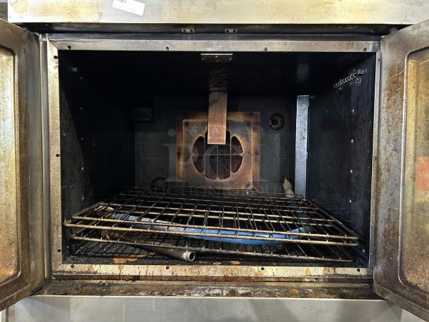 Alt text: WOLF WKGD-2 Double Deck Gas Convection Oven interior, showing condition. Oven shelf and metal components visible.