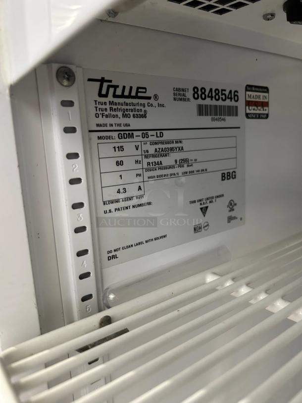 True GDM-5-LD Countertop Merchandiser, 5 Cu. Ft., Black, one glass door, great condition, tested, made in USA, model label visible.
