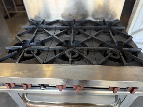 Wolf WX36-6BN 36" 6-burner gas range with standard oven in excellent condition. Features red knobs, tested and working.