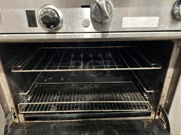 Southbend S36D gas range oven interior, showcasing dual oven racks and control knobs. Excellent condition, oven tested.