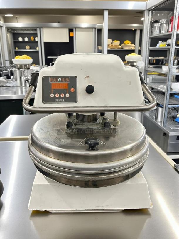 Proluxe DP2010 12" dual-heat dough press, 208V, 4600W. Heavy duty, manual operation. Blaze Pizza label, stainless steel.