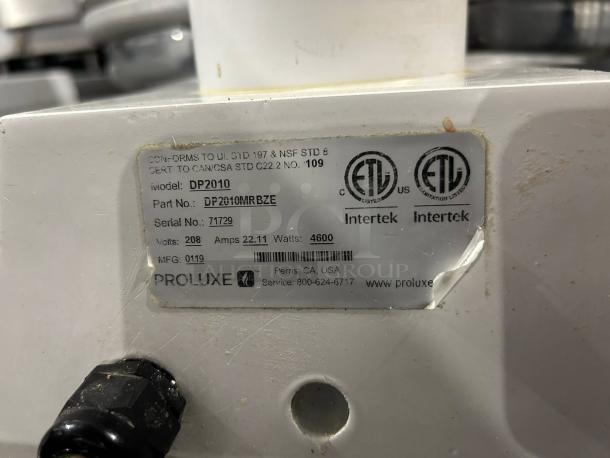 Proluxe DP2010 dough press label showing model, serial number 71729, 208V, 4600W, Intertek certified, used condition.