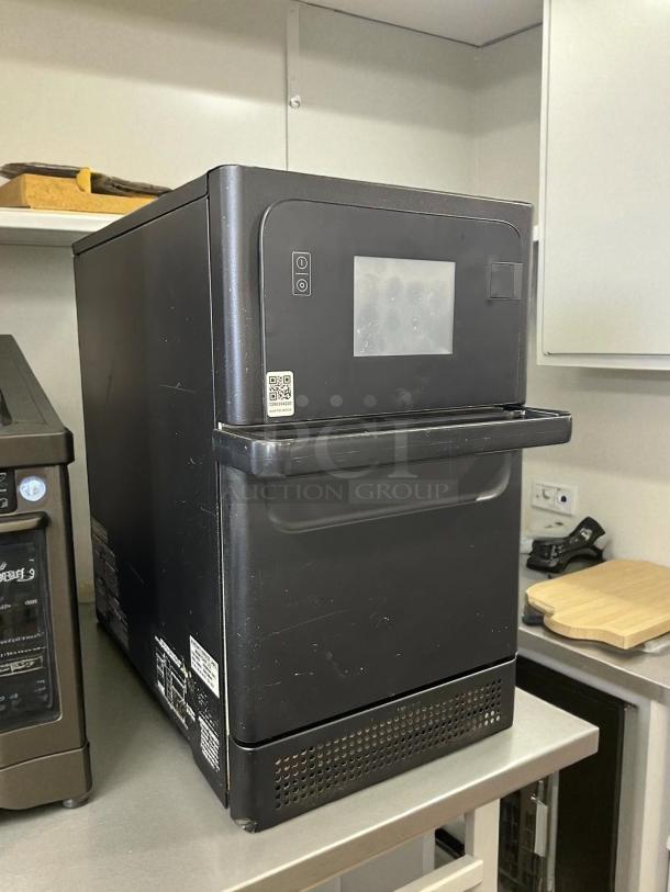 Merrychef eikon E1S high-speed microwave convection oven. Black, tested, working, 208-240v/1ph. Some surface wear visible.