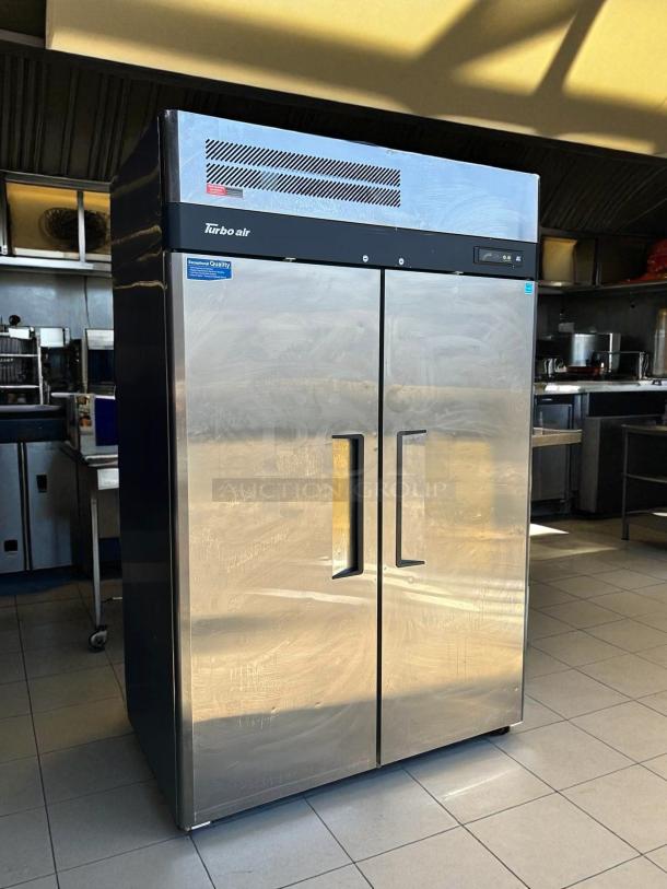 Turbo Air M3F47-2-N 52" stainless steel 2-door reach-in freezer in working condition, featuring brand logo and quality label.