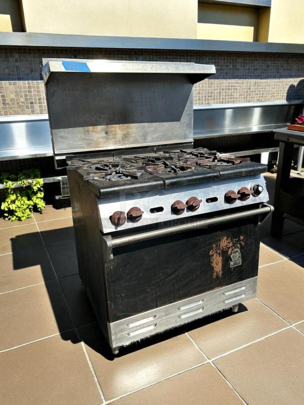 WOLF commercial 6-burner range and oven, natural gas, tested, excellent condition, visible wear on the front panel.