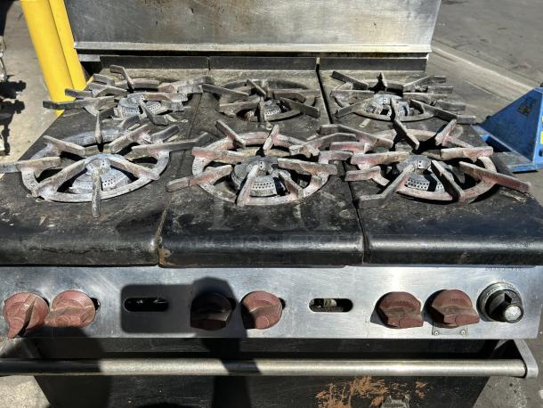 WOLF commercial 6 burner range and oven in excellent condition; natural gas, tested and working, with red control knobs.