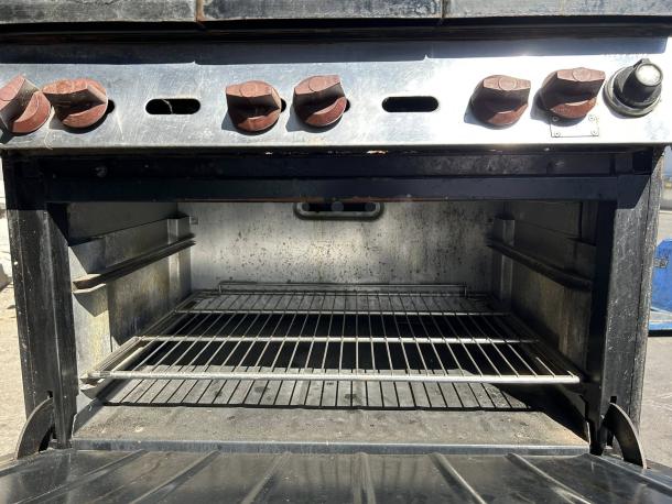 WOLF Commercial 6 Burner Range and Oven, natural gas, excellent condition, tested and working, red knobs visible.