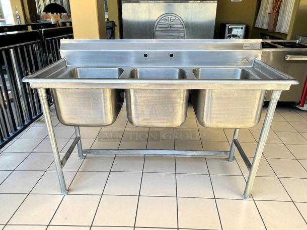 Advance Tabco T9-3-54 Regaline stainless steel three-compartment commercial sink in excellent condition, tested and working.