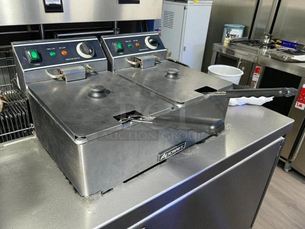 Adcraft DF-6L/2 double tank deep fryer in stainless steel. Tested and working. Features dual controls and visible brand label.
