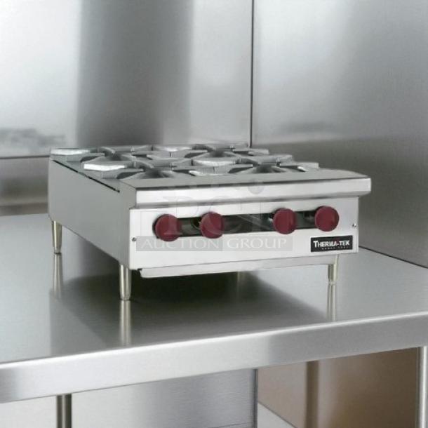 Brand new Therma-Tek TCHP24-4 gas hotplate, four burners, red controls, stainless steel, original packaging.
