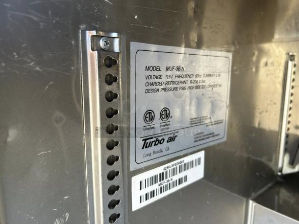 Turbo Air MUF-36-N undercounter freezer, silver, model label showing electrical specs, tested and working.