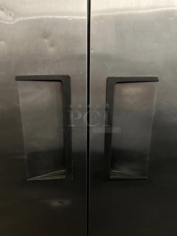 True T-49-HC 54 1/8" solid door reach-in refrigerator, stainless steel finish, dual handles, tested and working.