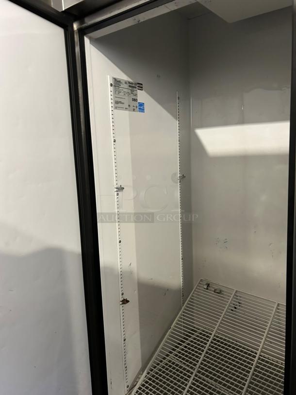 True T-49-HC reach-in refrigerator interior view, solid door, tested and working. Tags indicate model info and energy ratings.