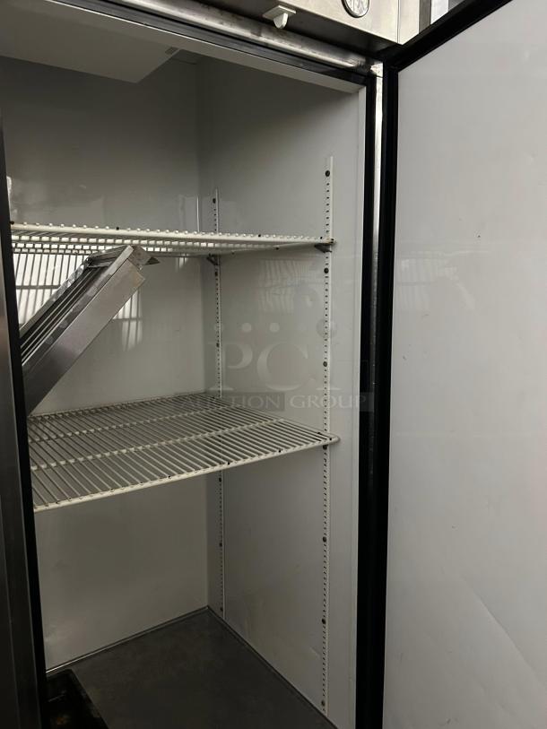 True T-49-HC 54 1/8" solid door reach-in refrigerator, in excellent condition, interior view showing shelves and clean surfaces.