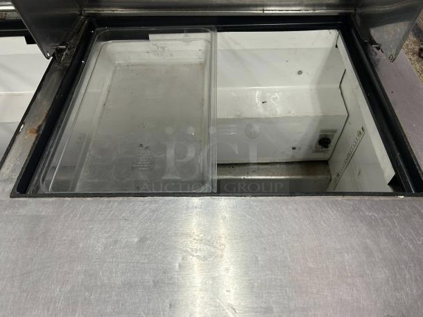 True TSSU-60-24M-B-ST-HC sandwich/salad unit in excellent condition, featuring a stainless steel top, interior compartments visible.