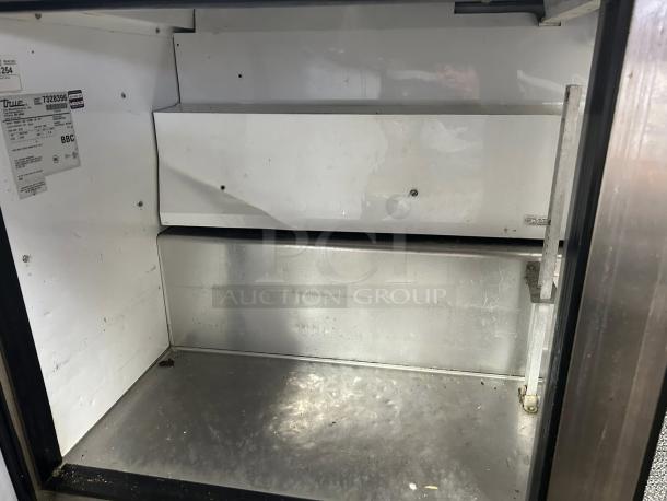 True TSSU-60-24M-B-ST-HC sandwich/salad unit interior, stainless steel, hydrocarbon refrigerant, excellent condition, visible labels.