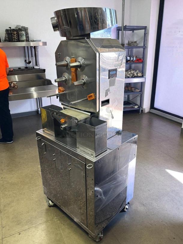 Citrocasa 8000 SB-ATS Advance Citrus Juicer, stainless steel, visible wear, on caster wheels, sold as is.