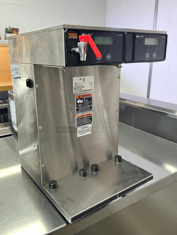 Bunn 38700.0013 Axiom APS Twin Airpot Coffee Brewer, stainless steel, tested and working, warning labels visible.