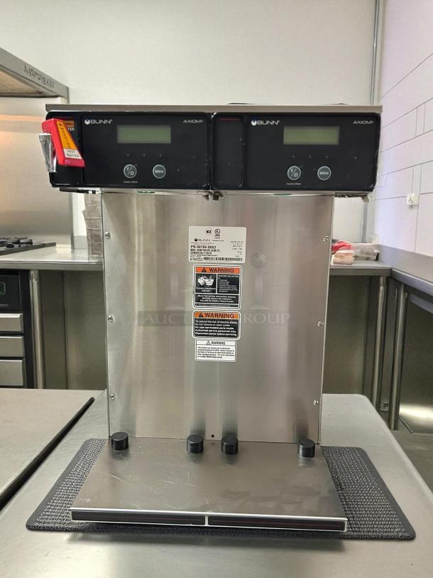 Bunn 38700.0013 Axiom APS Twin Airpot Coffee Brewer, stainless steel, tested, working, warning labels visible.