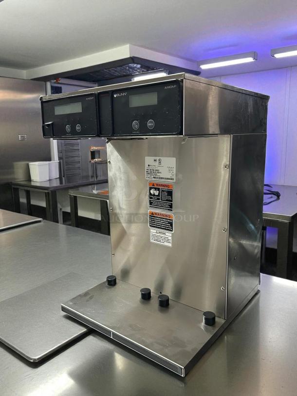 Bunn 38700.0013 Axiom APS Twin Airpot Coffee Brewer, stainless steel, 120/240V, tested and working, control panels visible.