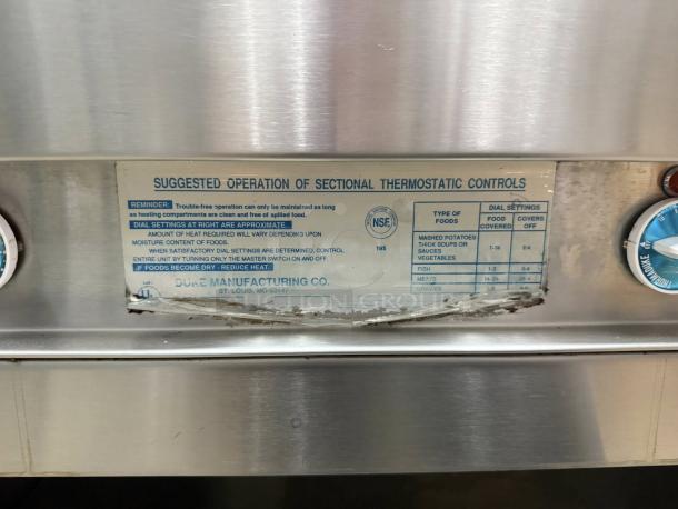 Stainless steel Duke E-4-CBSS electric steam table with label showing operation instructions. Four sealed wells, 208V/60Hz/3Ph. Fully tested.
